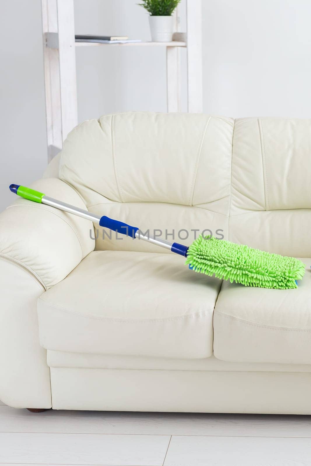 New clean green microfiber mop floor wiper cleaning sweeping tool lying on sofa - tools for cleaning services and domestic work housekeeping by Satura86