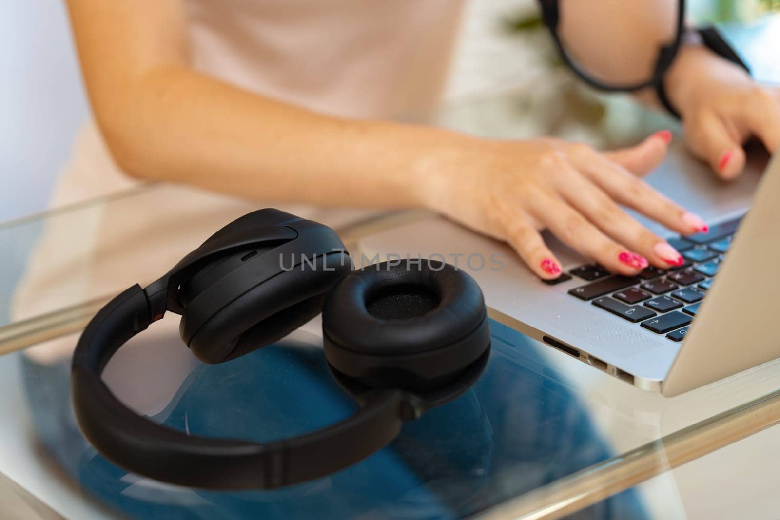 Close up photo of woman hands typing on laptop keyboard at the office