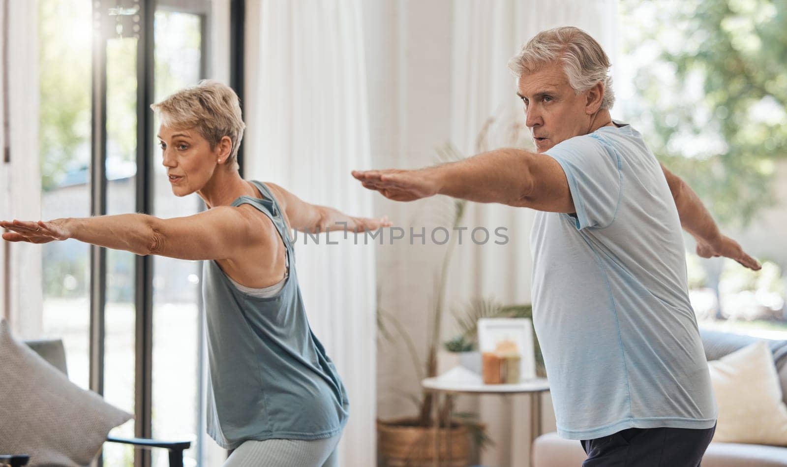 Senior couple, exercise and fitness during aerobics or yoga workout in the lounge at home for health and wellness in retirement. Old man and woman stretching for healthy lifestyle in Australia house.