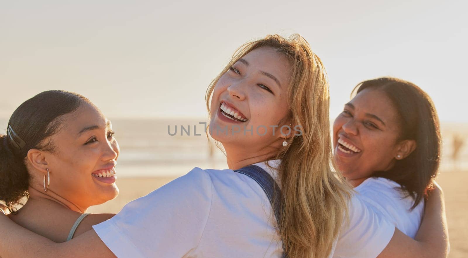 Portrait, hug and women friends at beach for vacation, holiday or summer trip. Back view, smile and happy people enjoying quality time outdoors, having fun and bonding together by sea or ocean shore