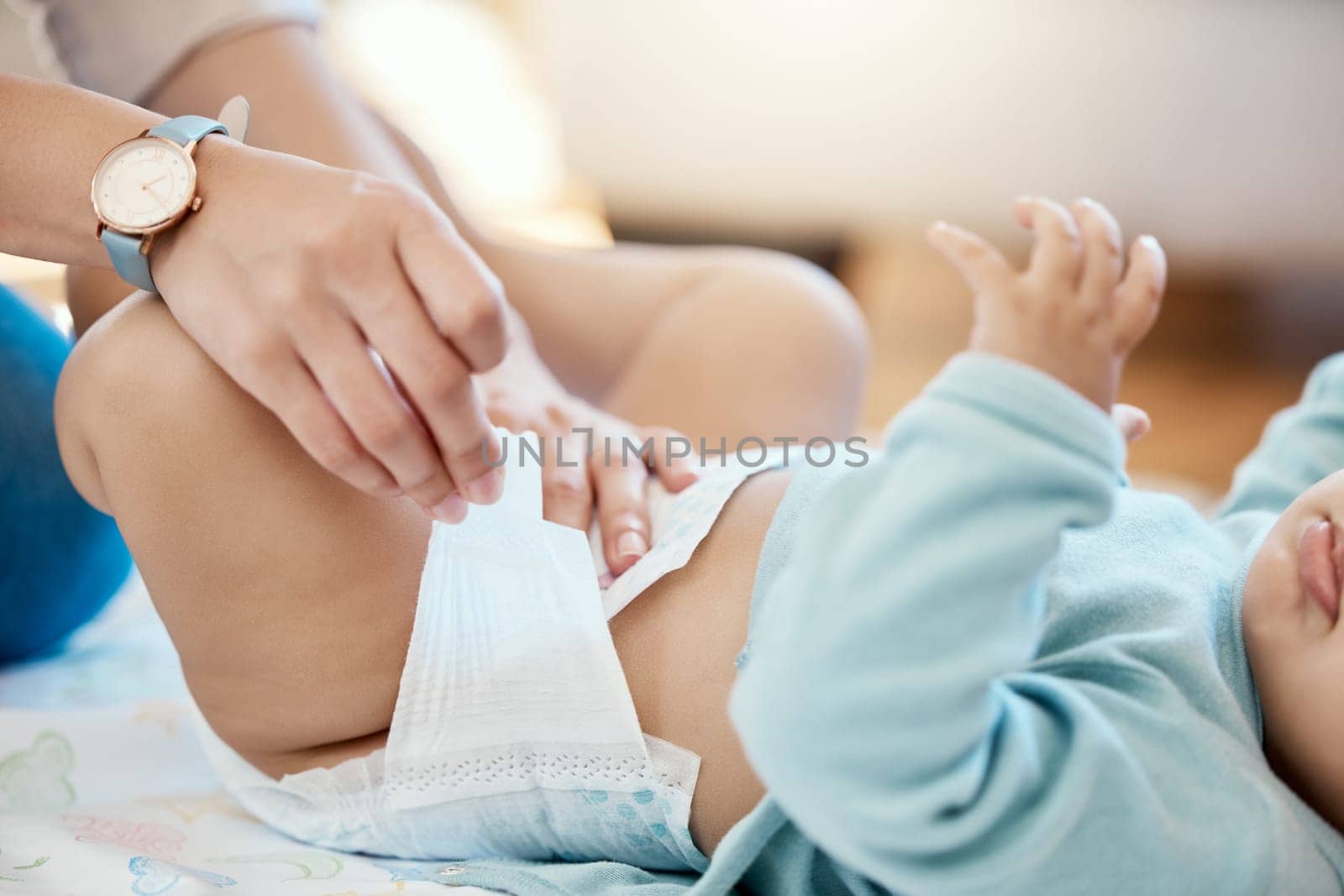 Diaper change, hands of mom and baby with calm cleaning time, bonding and parent with newborn getting dressed. Parenthood, child and mother changing nappy on bed with love, care and hygiene in home