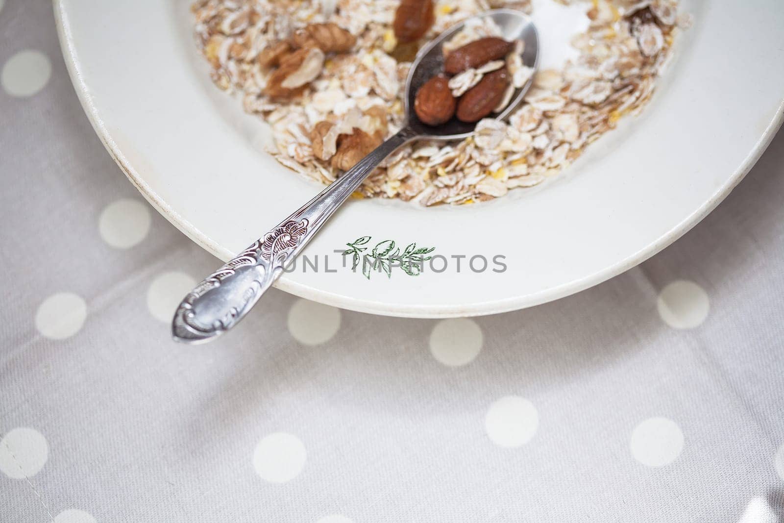 Oatmeal in bowl with nuts, useful food