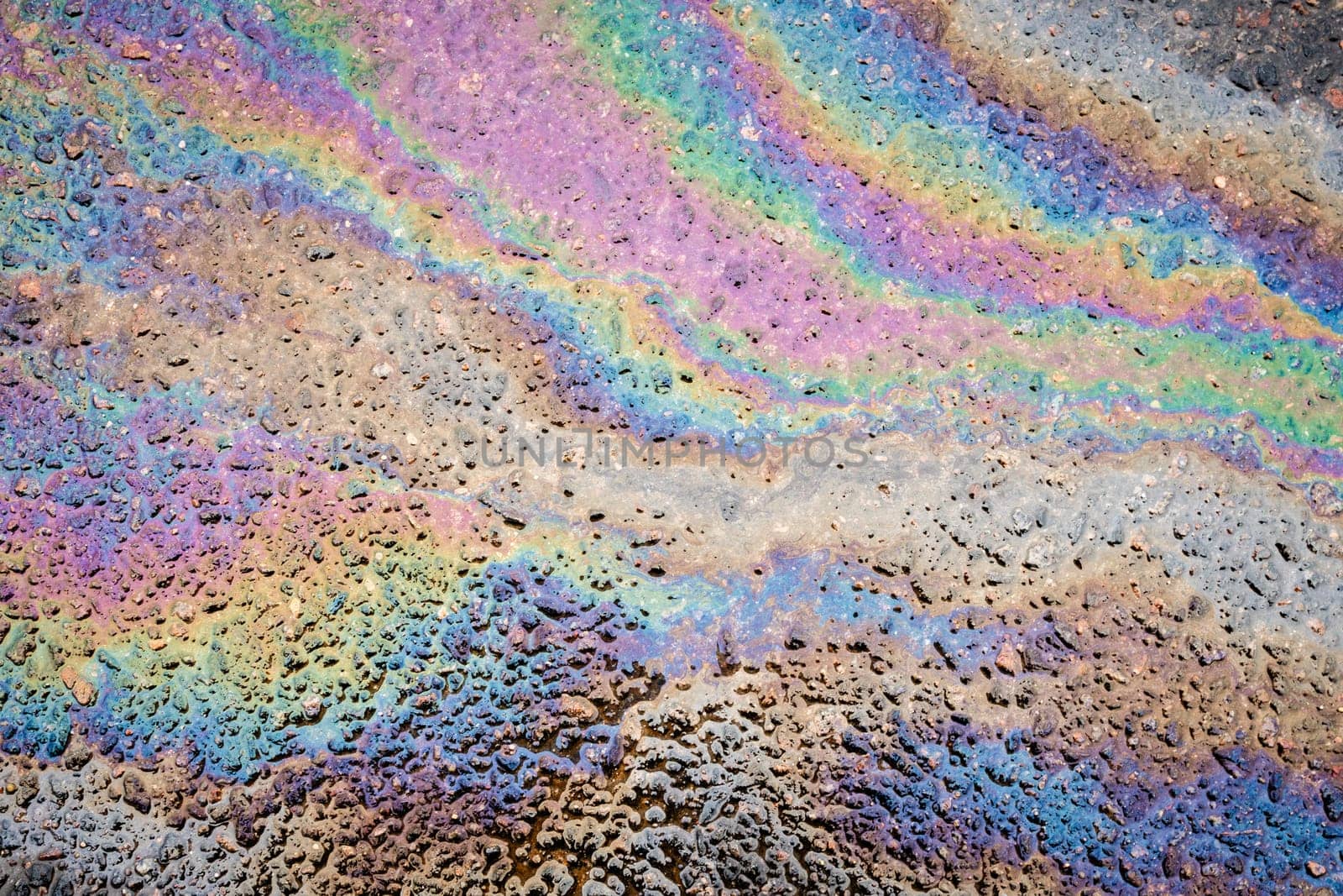 Traces and Stains of Oil or Gasoline on the Asphalt on the Road or Sidewalk