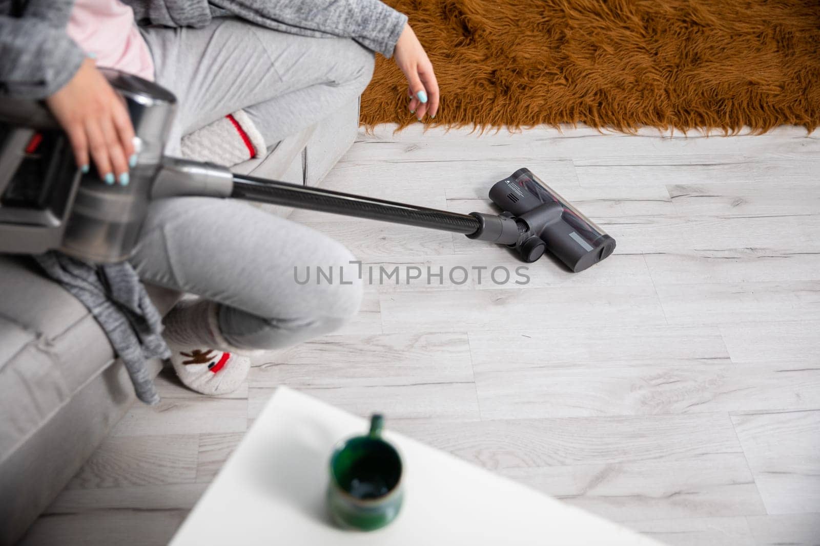 A well-deserved rest after a long cleaning of the floor throughout the house with a vacuum cleaner. Cleanliness and order requires regularity throughout the apartment.