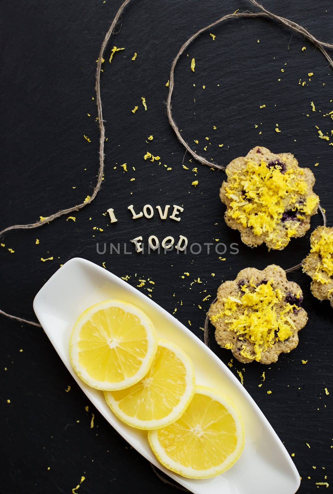 lemon cupcakes on a black background by sfinks