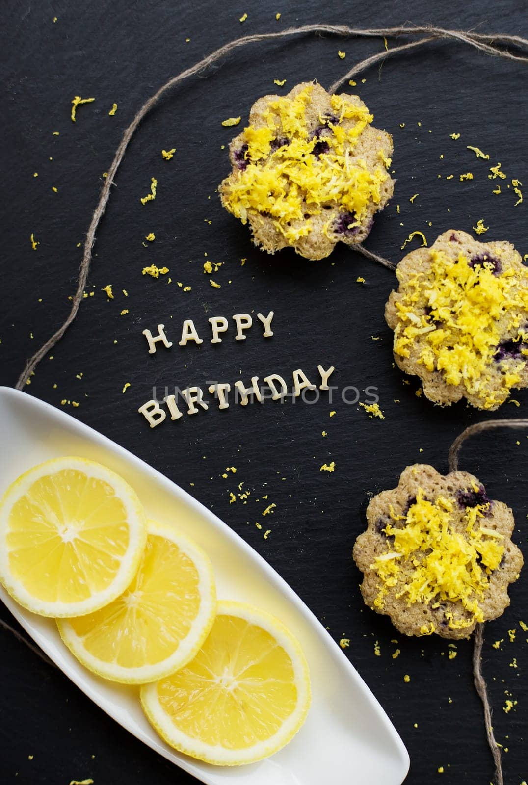 lemon cupcakes on a black background - inscription happy birthday
