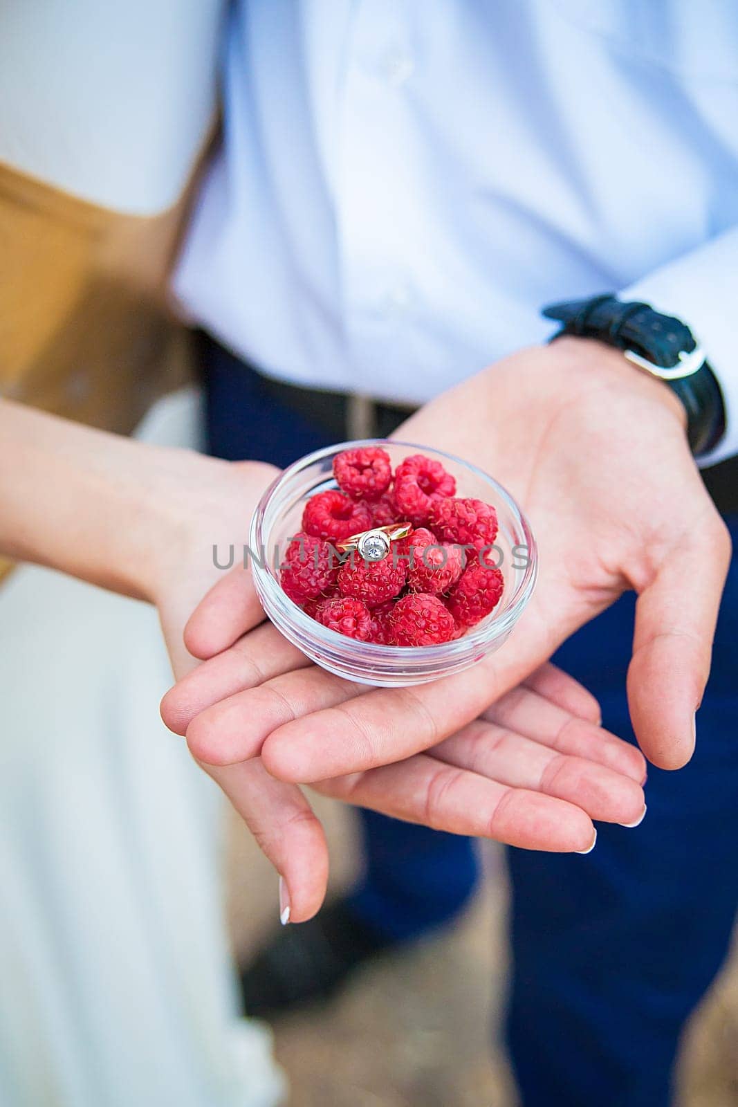 Wedding rings in a bowl with raspberries by sfinks