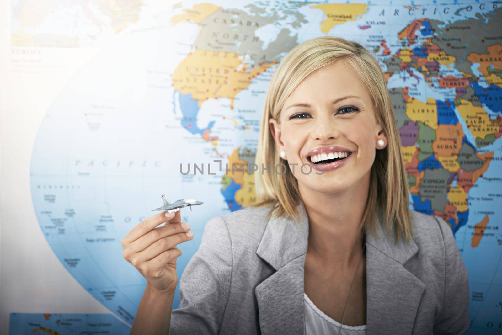 Travel agency portrait, plane and happy woman, business agent or consultant planning airplane journey, trip or global tour. World map, holiday transportation and person working on vacation route plan by YuriArcurs