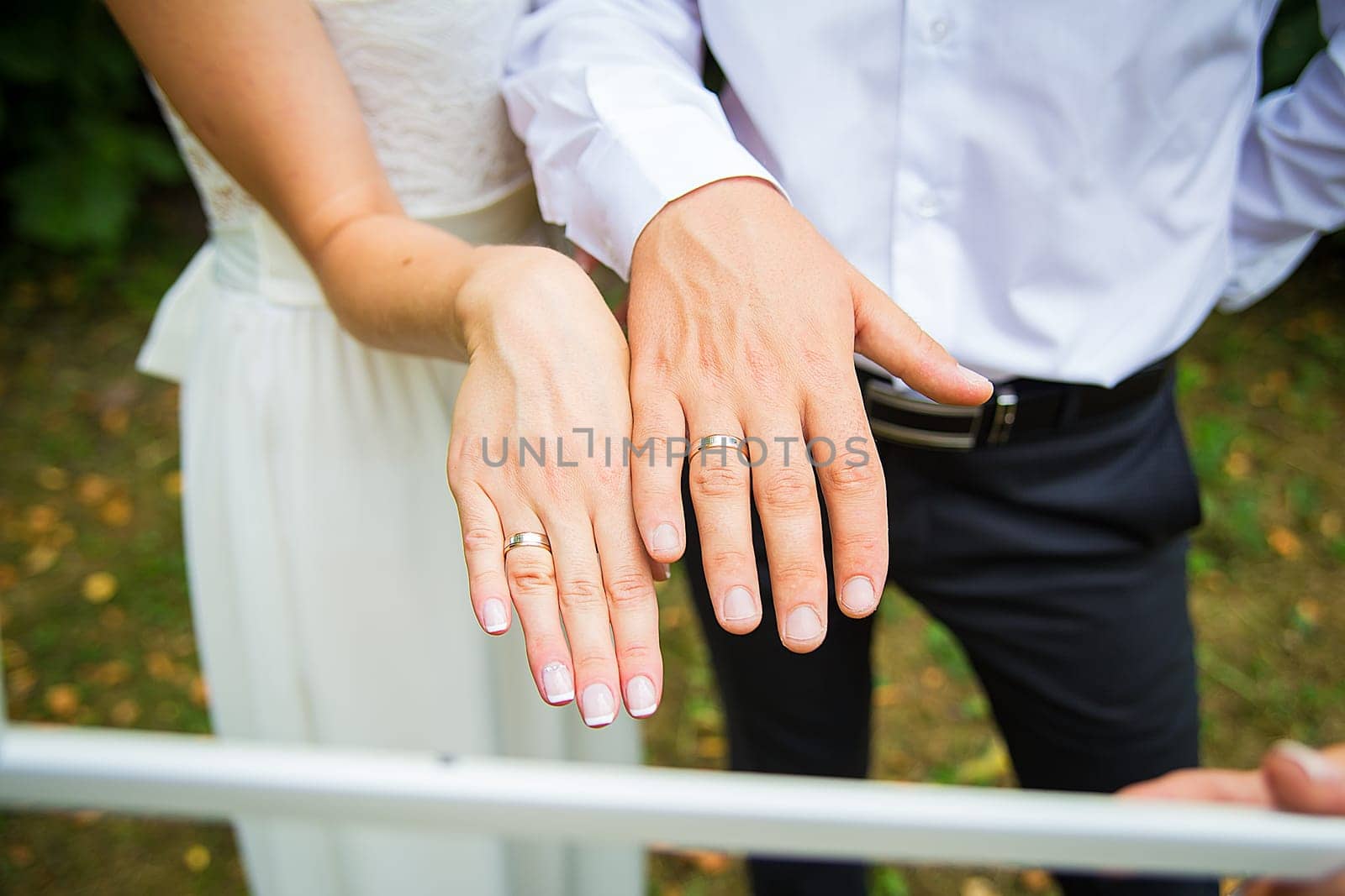 Newly wed couple's hands with wedding rings.