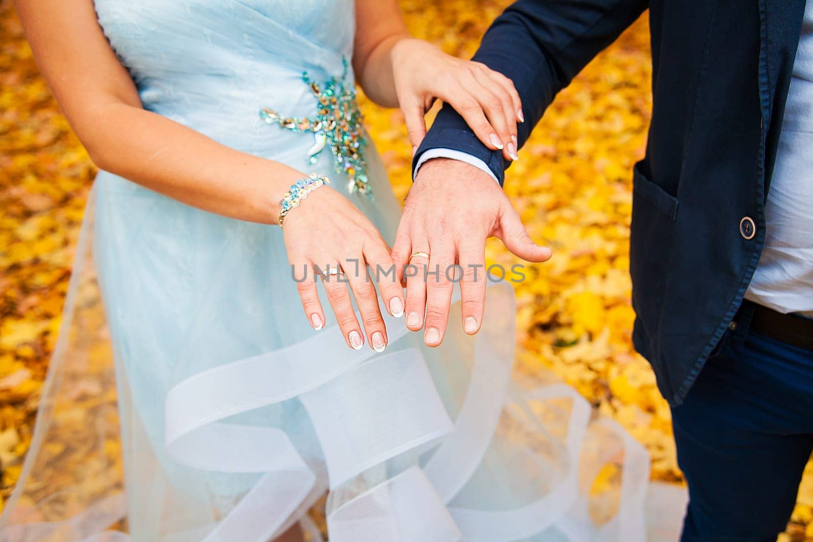 Newly wed couple's hands with wedding rings.
