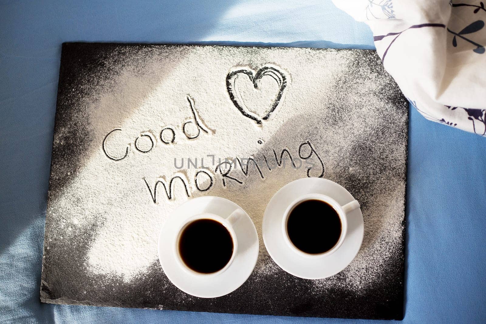 good morning inscription flour on a board with cups of coffee, heart Valentine's day.