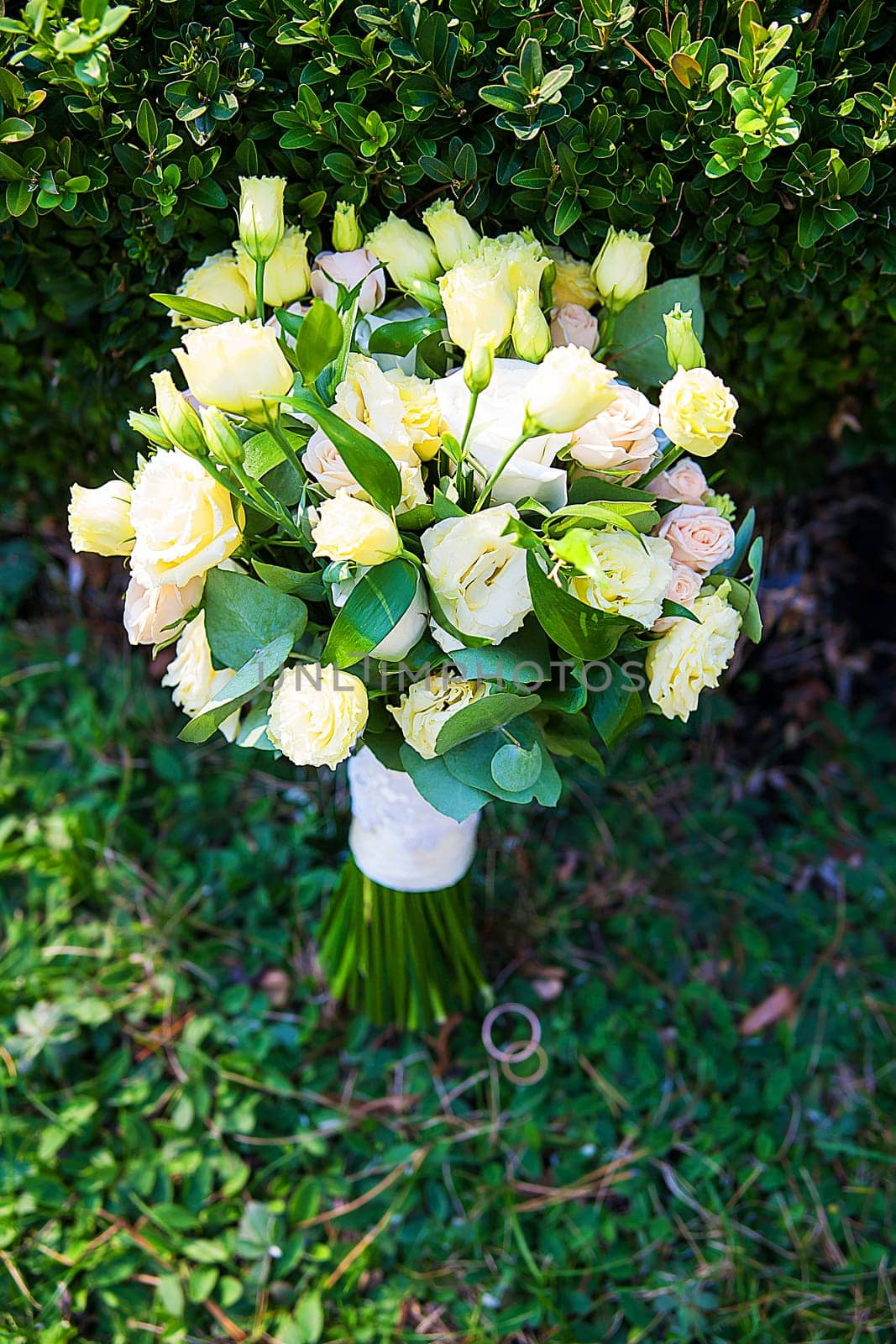 beautiful bridal bouquet lying on the green grass.