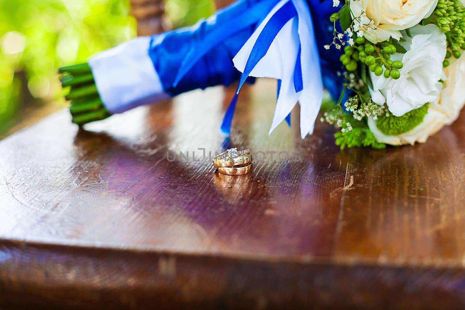beautiful bridal bouquet and rings, lying on chair by sfinks