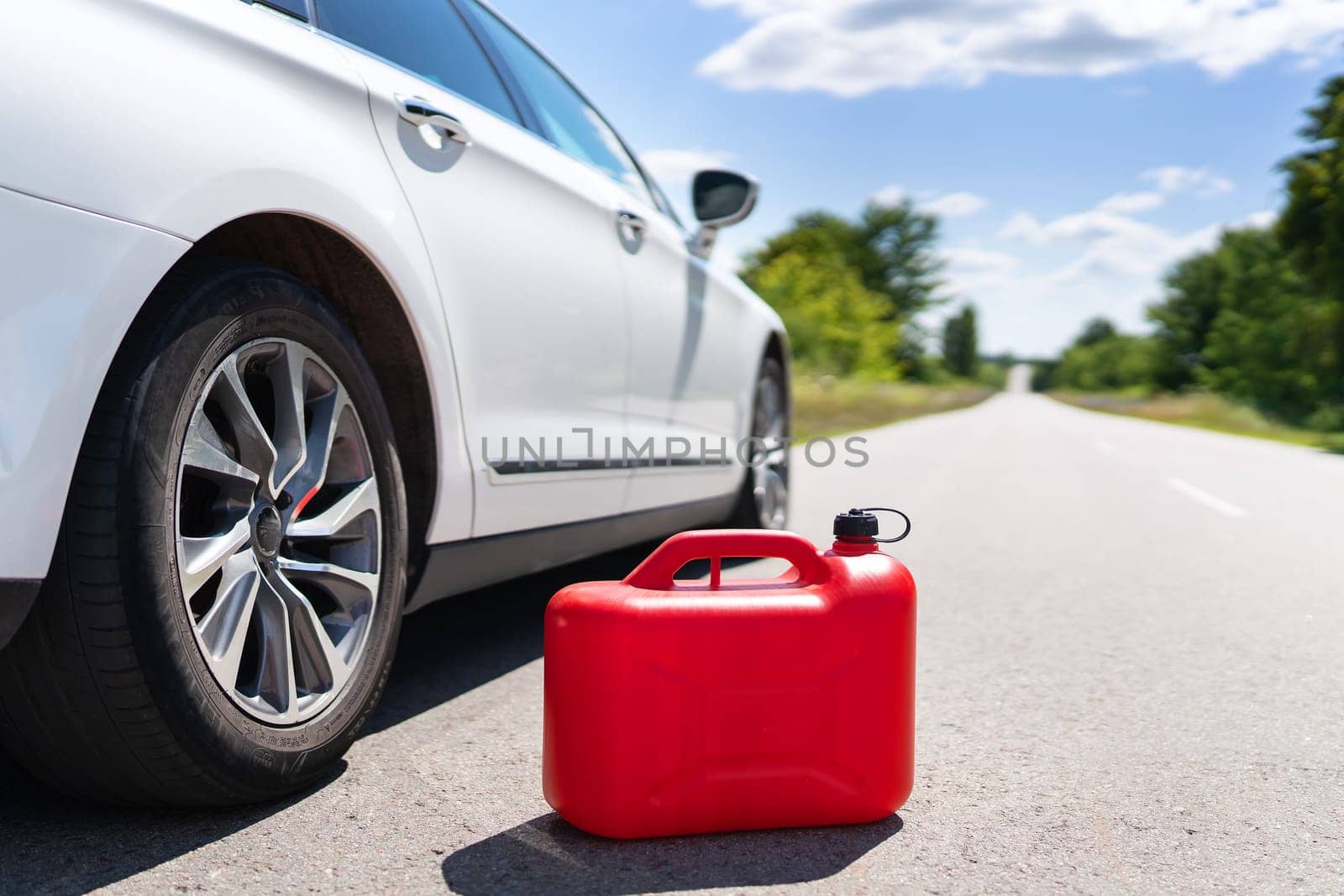 Empty car tank from a red canister on the side of the road. Fuel problem. Place for an inscription