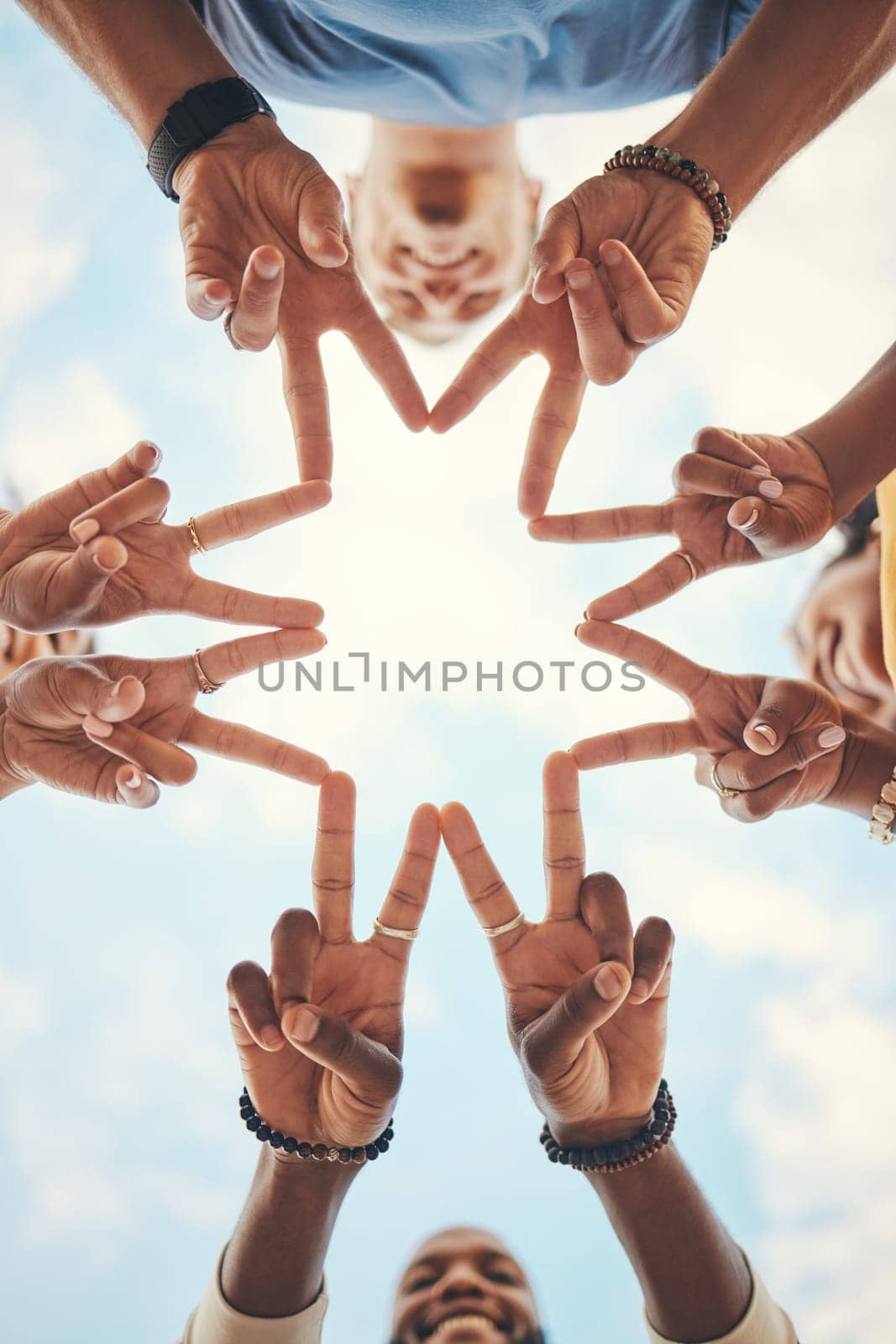 Group hands, star finger and support, freedom and motivation on blue sky background. Closeup teamwork friends below frame v sign, connection and link of creative solidarity, hope vote and peace trust.