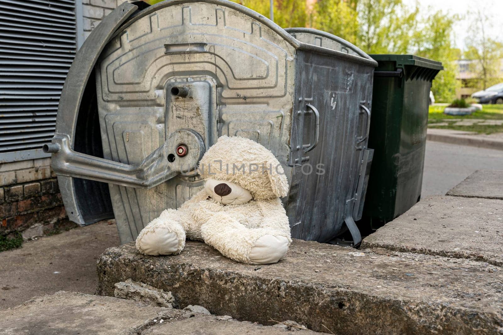abandoned teddy bear near the dumpsters. concept of betrayal by audiznam2609