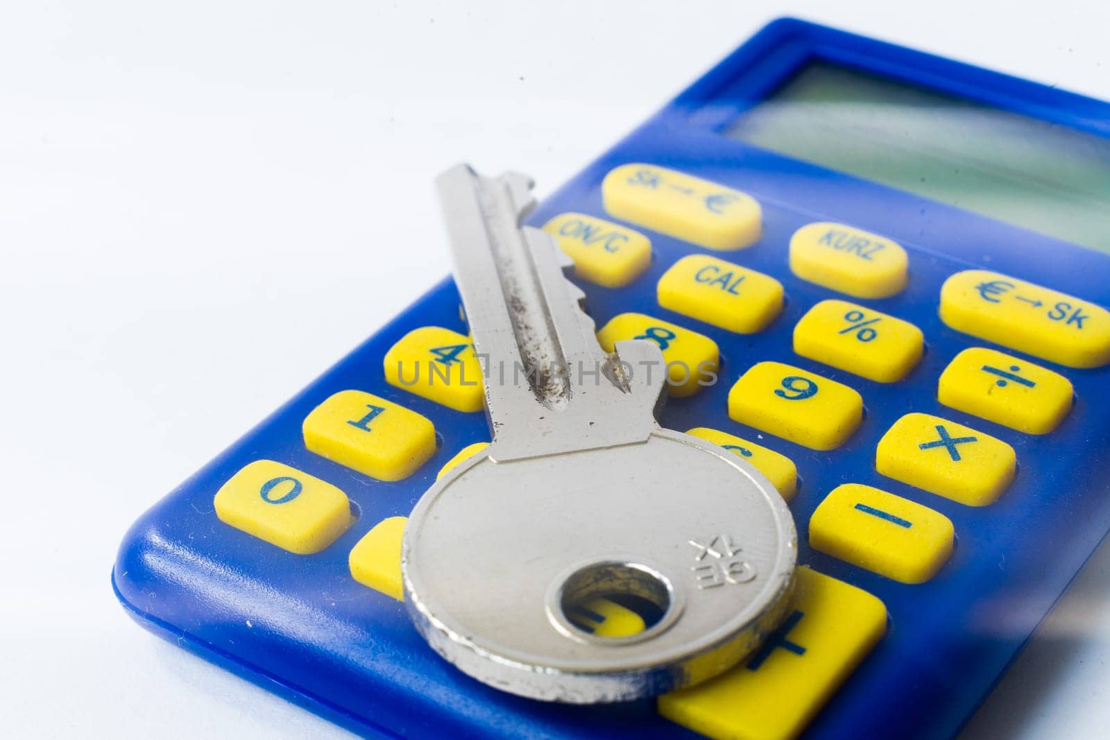 The calculator and home key macro closeup, white background by Zelenin