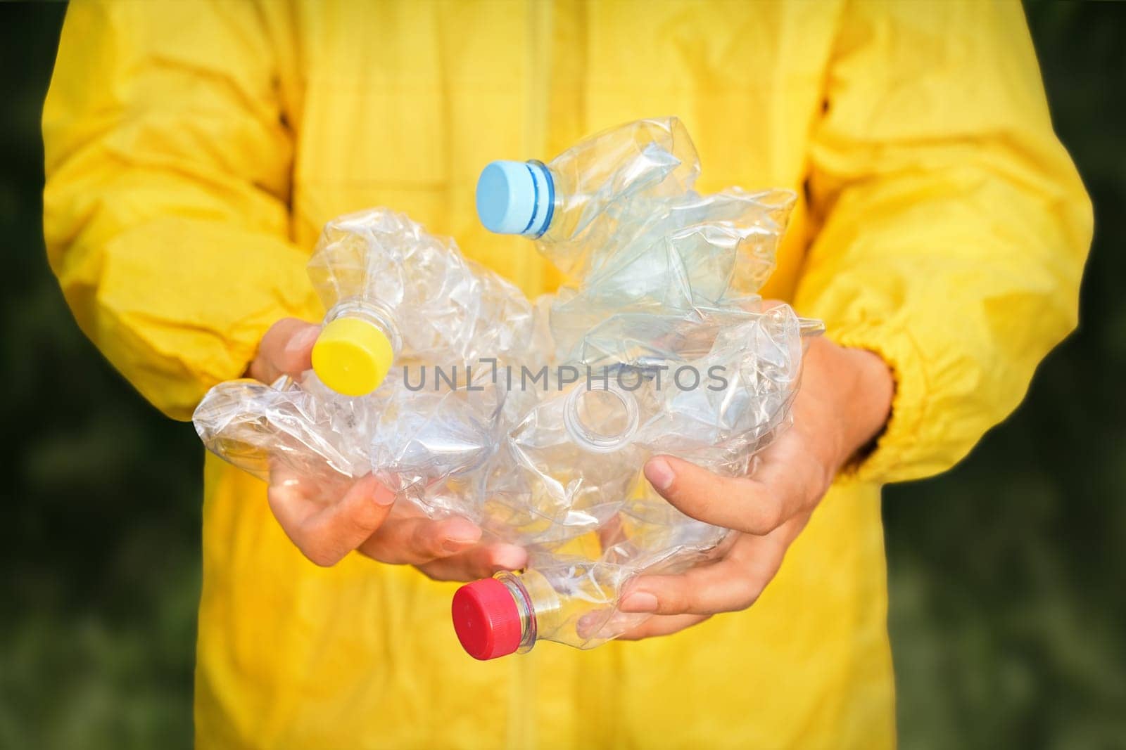 Volunteer hands holding bottle plastic garbage. Environment clean up park cleaning trash nature. Volunteer cleaning forest. PET waste plastic hand trash pick up garbage nature. PET plastic pollution by synel
