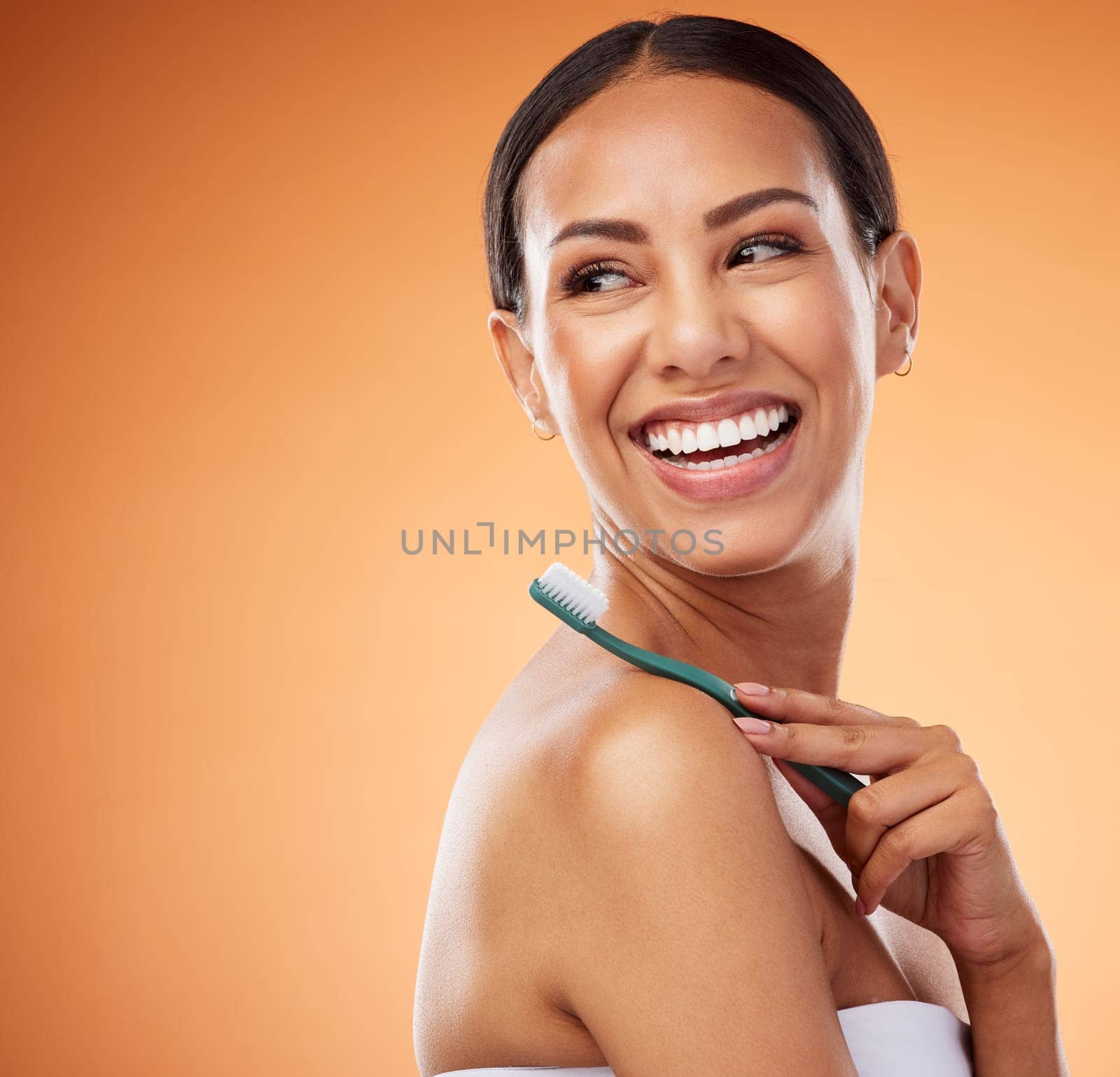 Toothbrush, dental care and woman with a smile in a studio with an orange background with mockup space. Healthy teeth, happy and girl model from Puerto Rico with mouth hygiene routine for oral health.