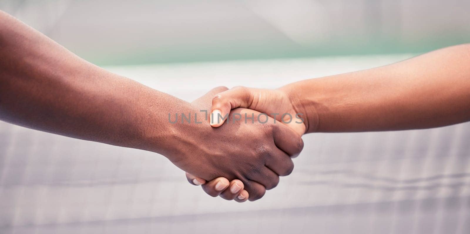 Closeup, handshake and sport for support, teamwork or respect outdoor at tennis court with diversity. Shaking hands, training and sports for fitness, exercise or training together with tennis player.