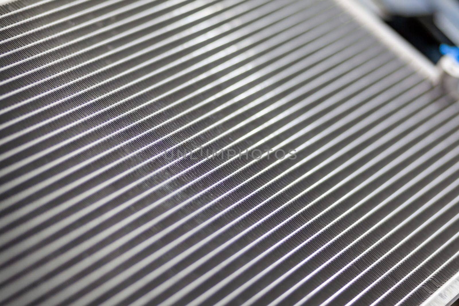 Texture of a car radiator. Engine cooler background. Vintage style. Radiator grille for car interior heater air conditioner, close-up. Radiator repair and replacement.