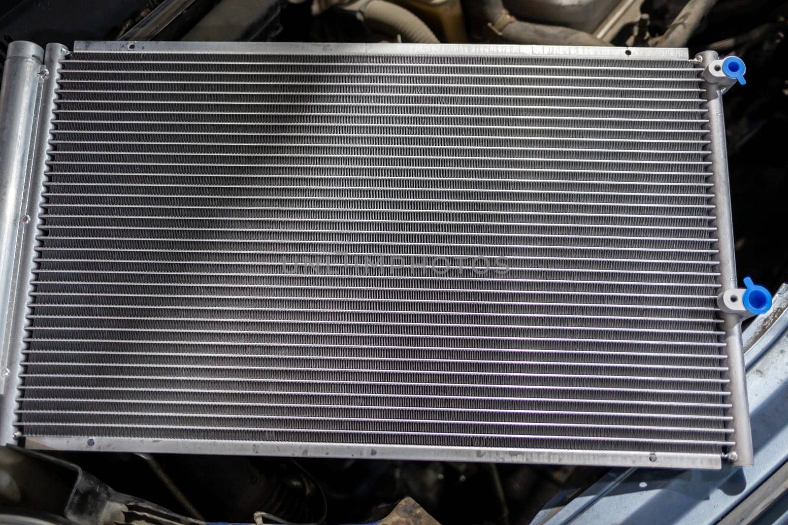 Texture of a car radiator. Engine cooler background. Vintage style. Radiator grille for car interior heater air conditioner, close-up. Radiator repair and replacement.