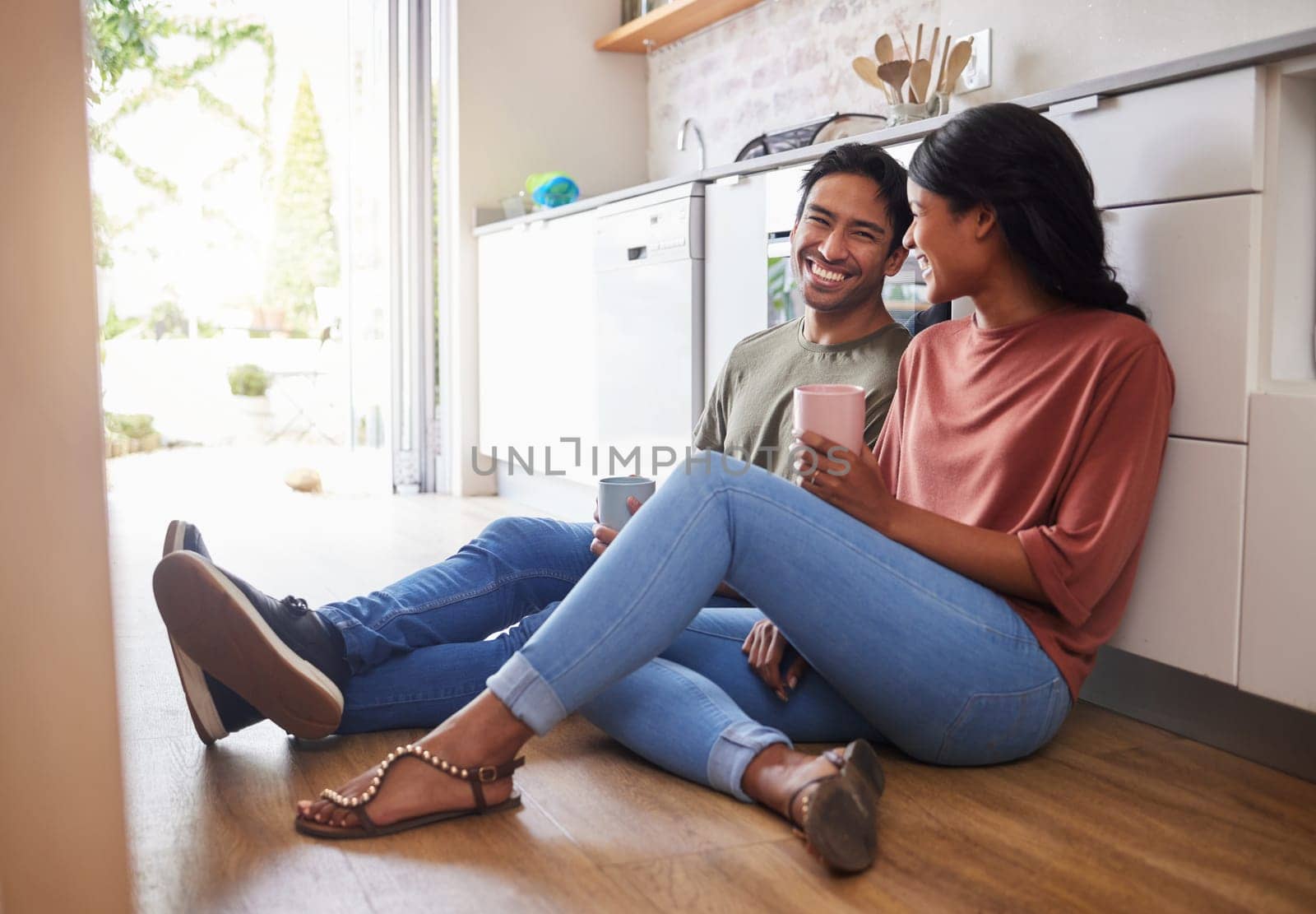 Couple communication, love with coffee in the kitchen and happy together to bond in the morning. Man and woman in India on floor, smile while in conversation and romance and healthy relationship. by YuriArcurs