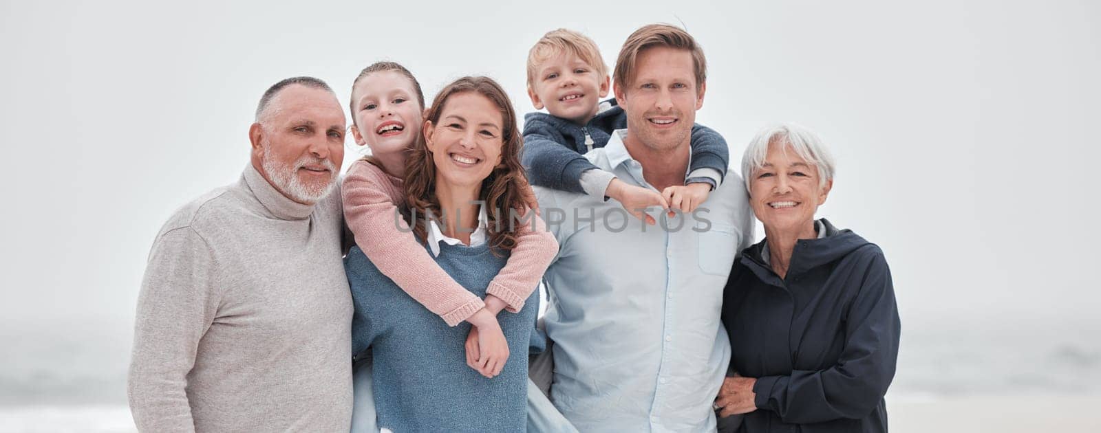 Family, children and beach with parents, grandparents and kids outdoor together while on holiday or vacation. Travel, love and bonding with a senior man, woman and grandkids spending time on a coast by YuriArcurs