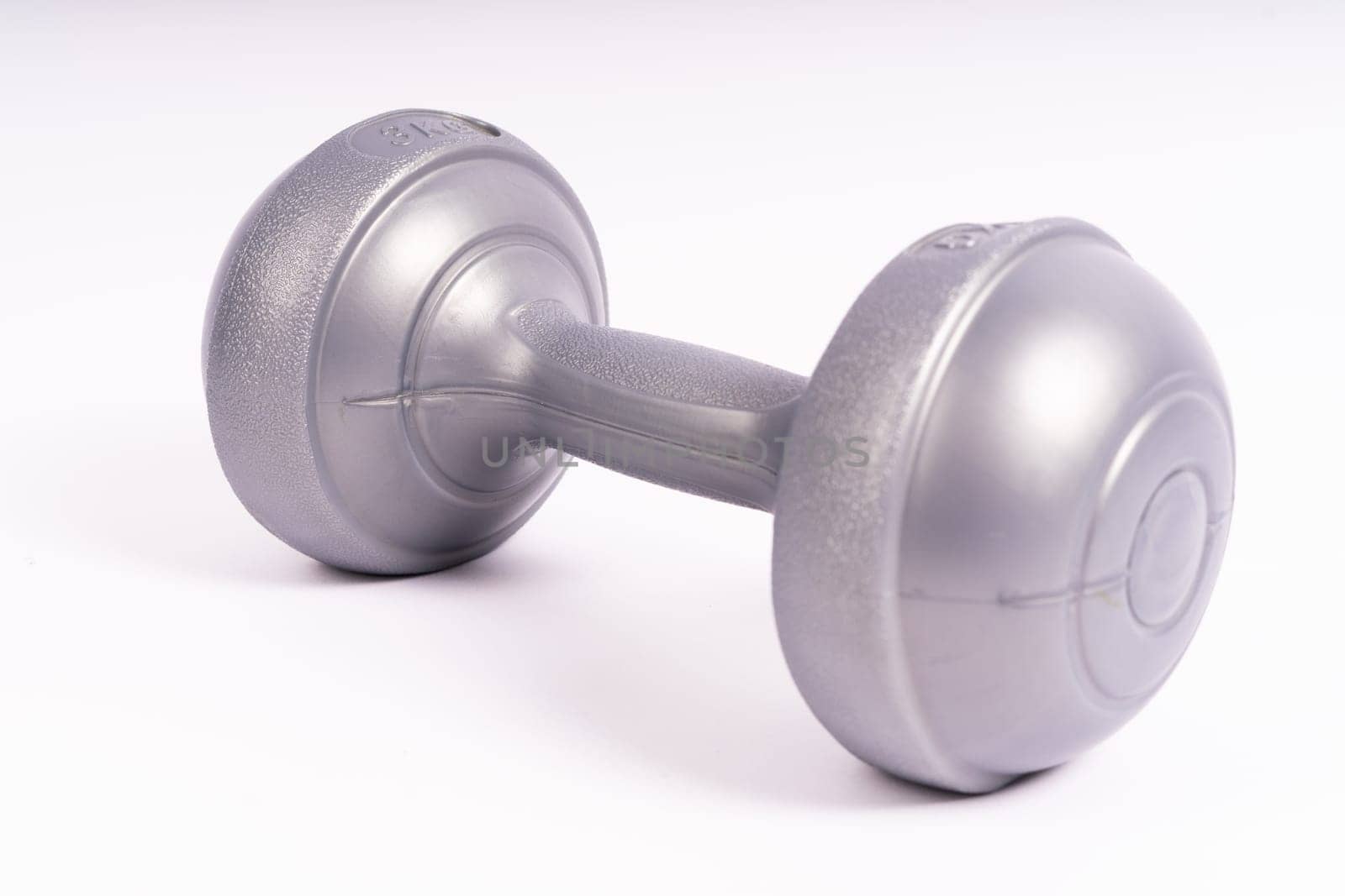 Grey dumbbell Side view closeup isolated on a white background