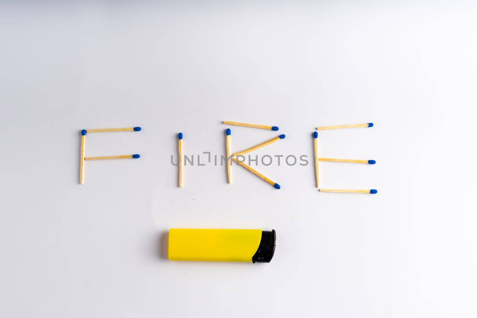 Lighter on a white background including matches box, word FIRE