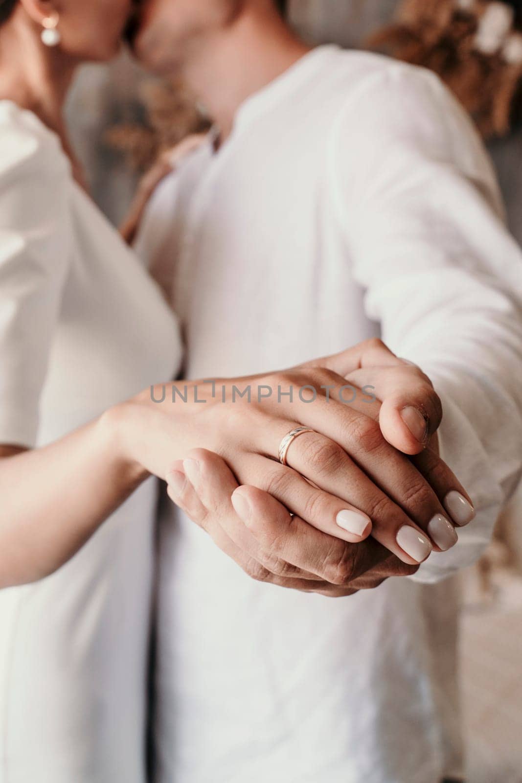 men woman holding hands. Couple holding hands close-up, bride and groom's hands by Matiunina