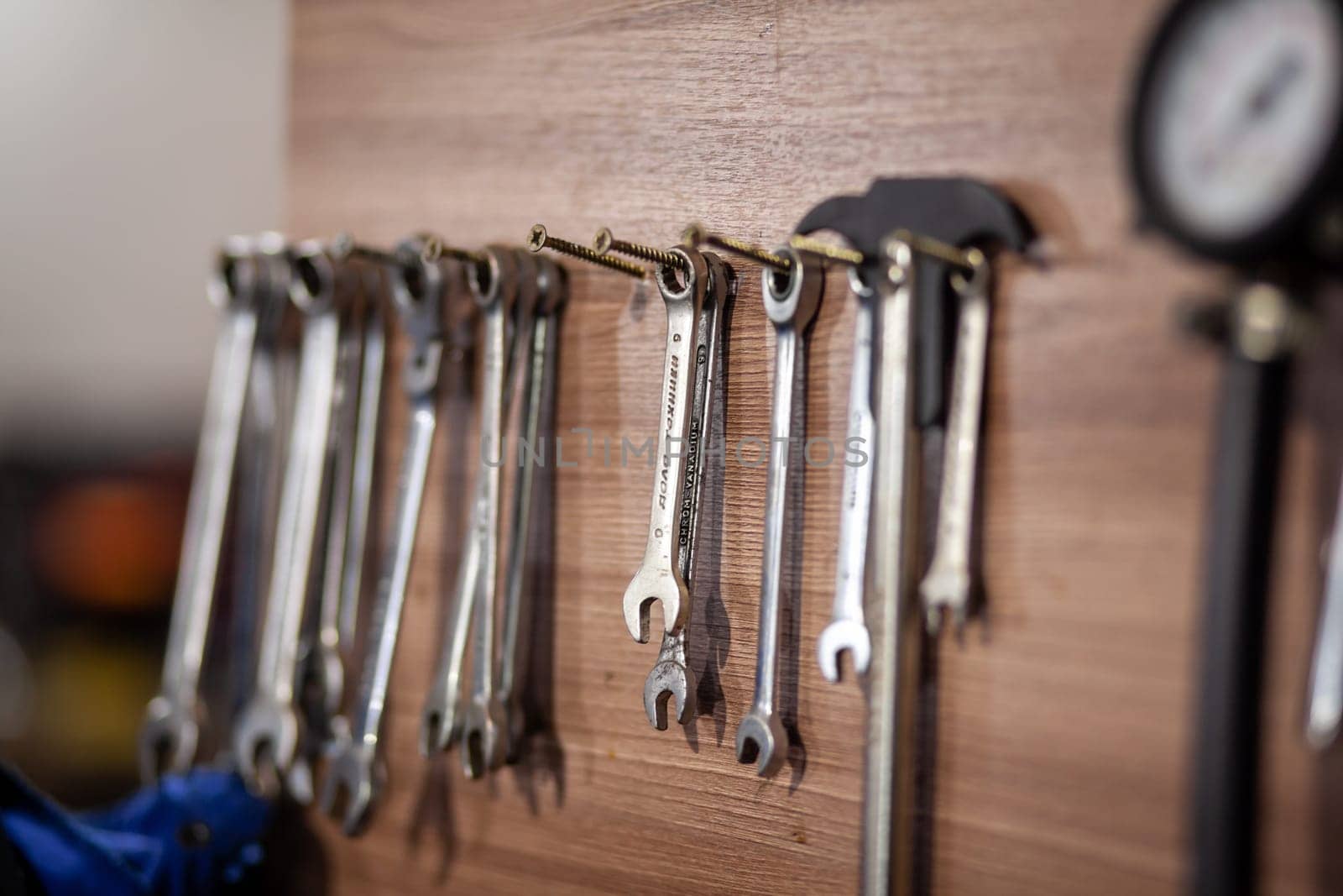 05.17.2023, Kemerovo, Moscow. Keys and work tools hang on the wall in a car repair shop or garage. Dirty, working tool of an auto mechanic