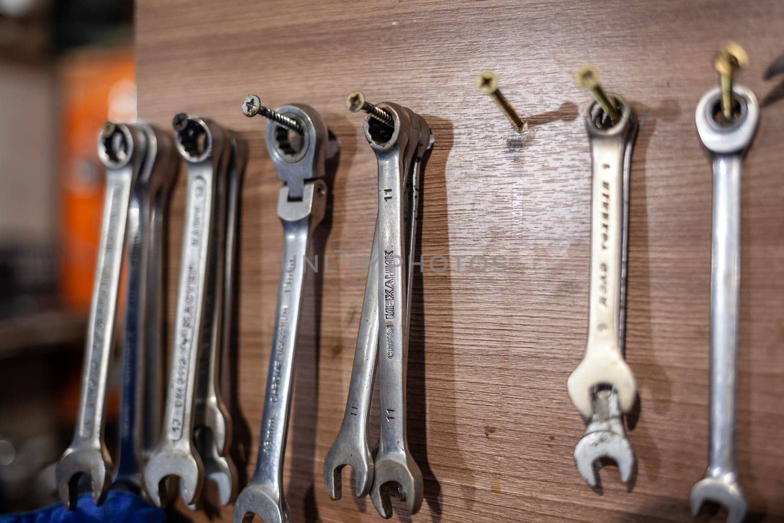 05.17.2023, Kemerovo, Moscow. Keys and work tools hang on the wall in a car repair shop or garage. Dirty, working tool of an auto mechanic