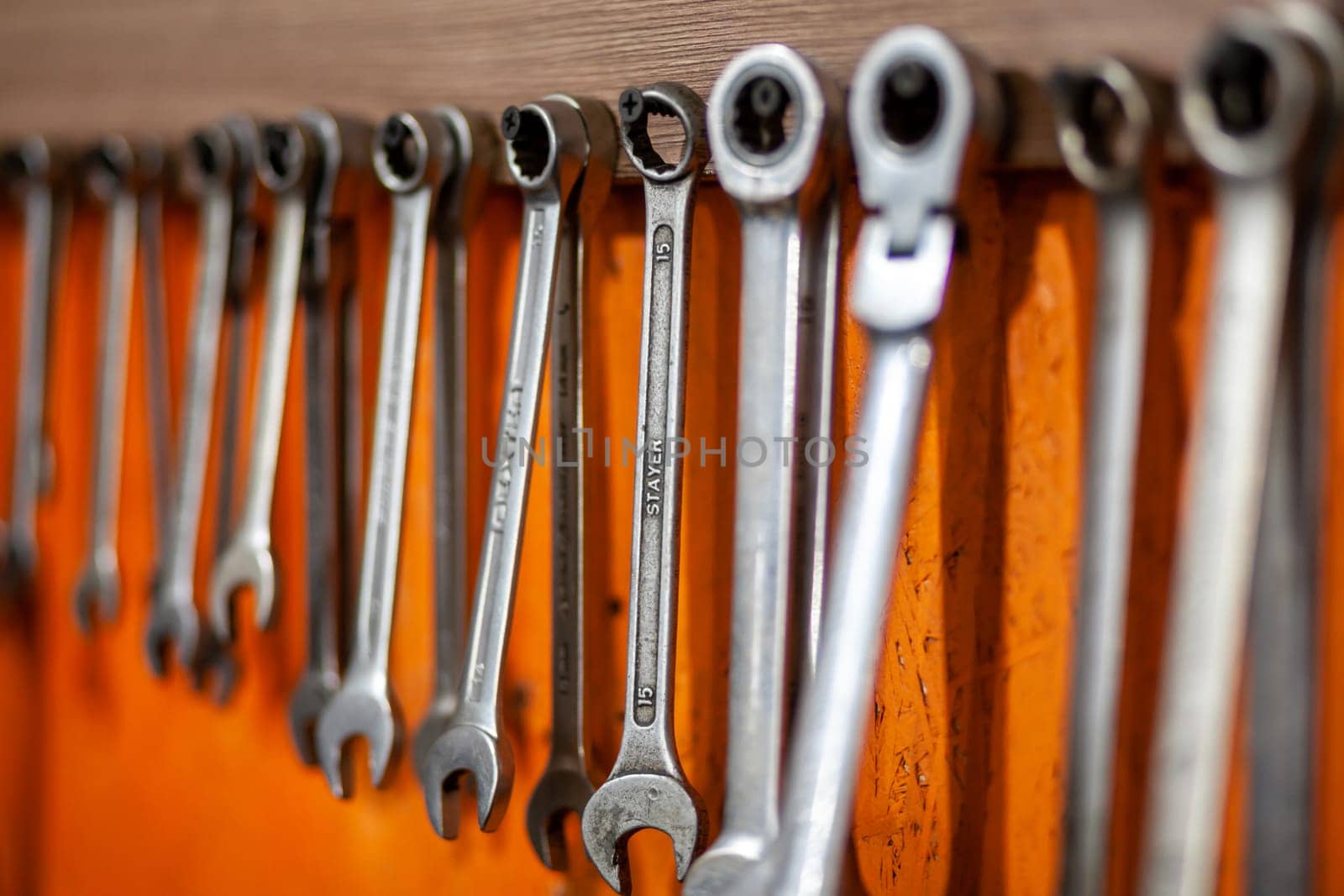 05.17.2023, Kemerovo, Moscow. Keys and work tools hang on the wall in a car repair shop or garage. Dirty, working tool of an auto mechanic