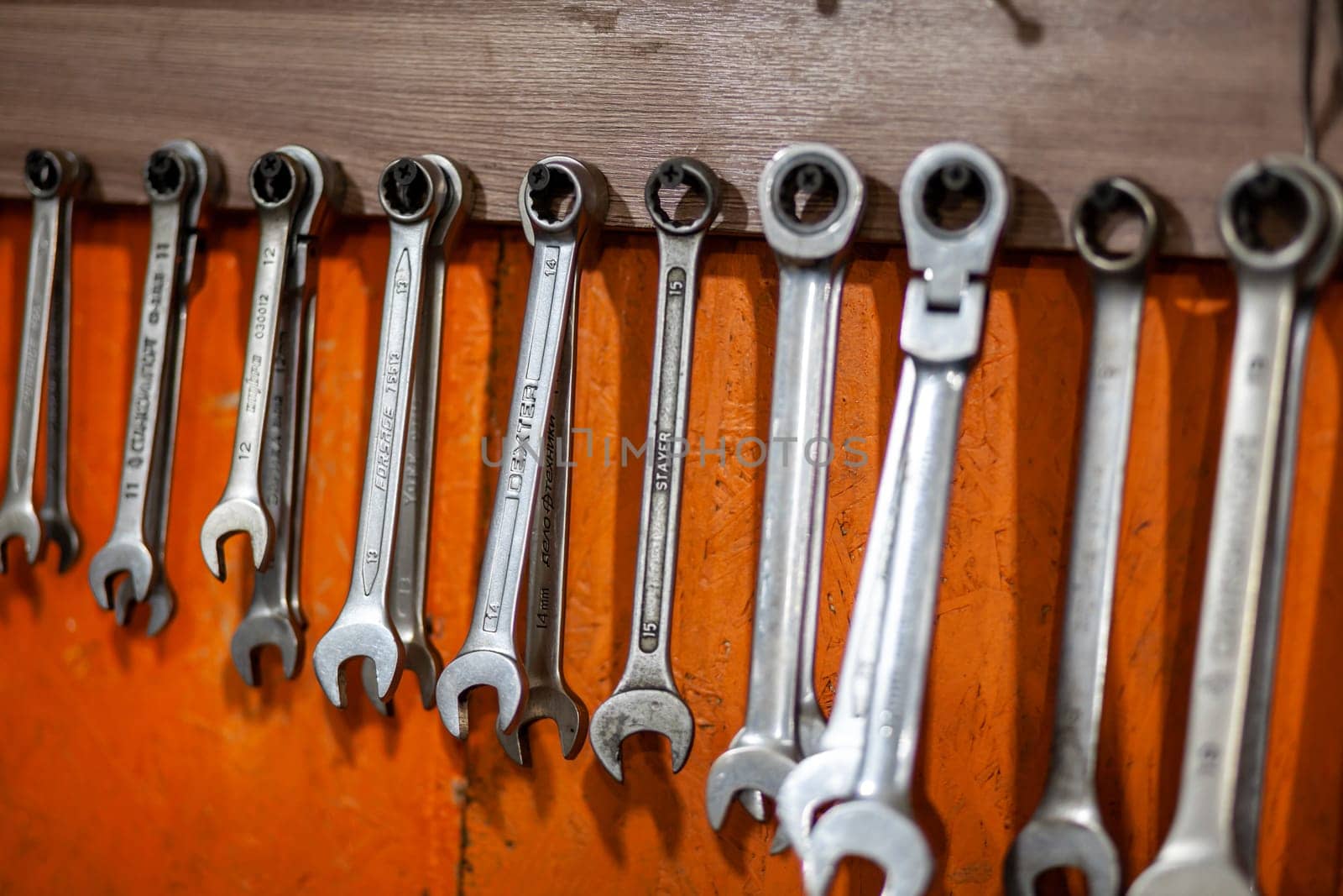 05.17.2023, Kemerovo, Moscow. Keys and work tools hang on the wall in a car repair shop or garage. Dirty, working tool of an auto mechanic