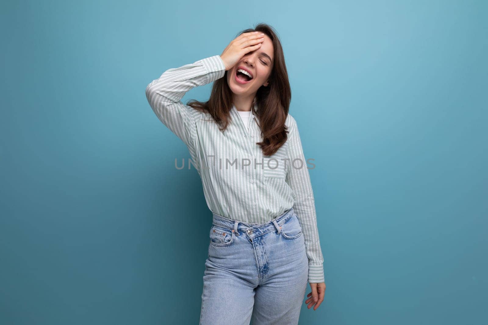 portrait of european model 25s woman with dark hair in casual clothes on studio background with copy space by TRMK