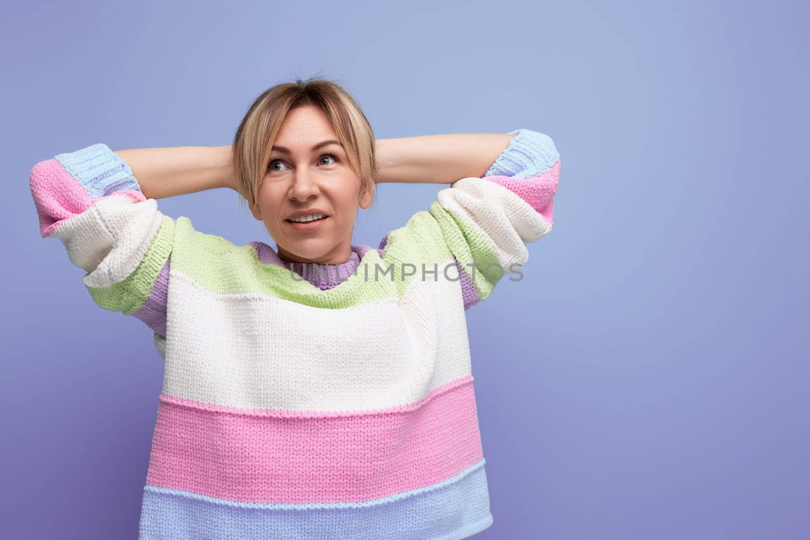 tired cute blondie woman stretching on purple background.