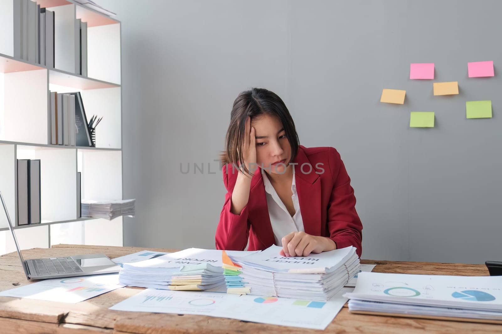 tired business woman sleepy and bored from sitting at a desk for a long time and has office syndrome by nateemee