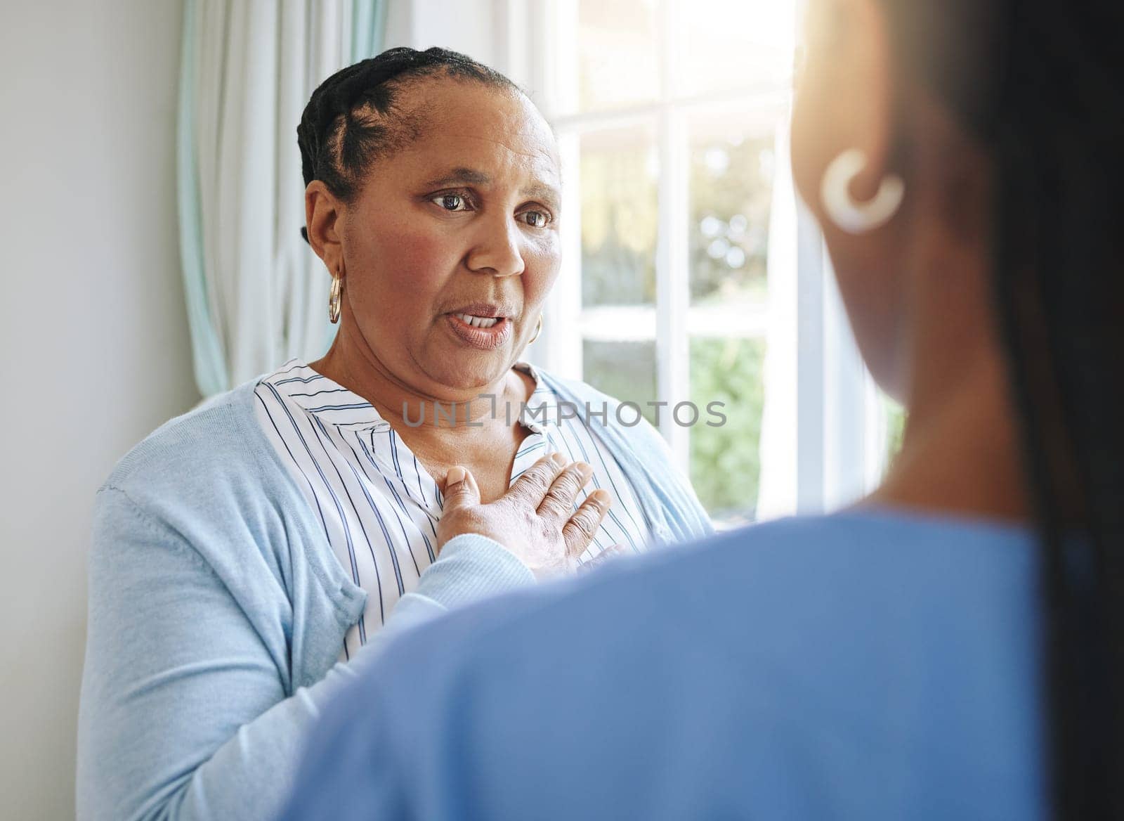 Senior healthcare, trust and a black woman with a doctor for medicine communication and medical problem. Support, consulting and an elderly patient talking to a nurse at a nursing home about health by YuriArcurs