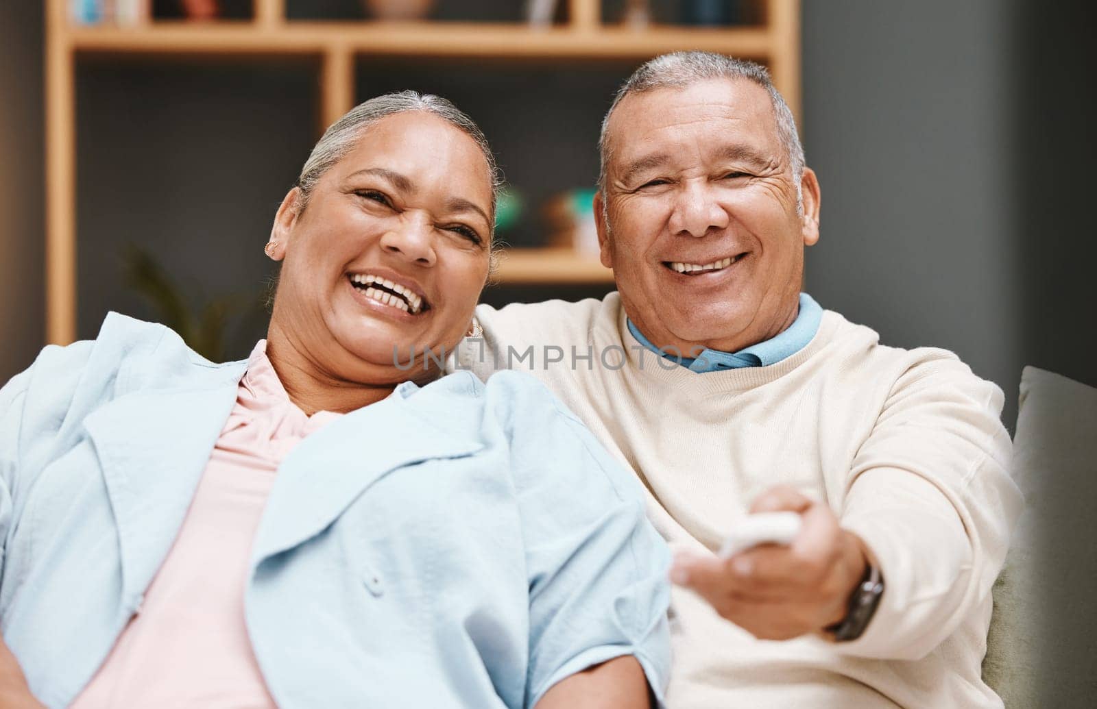 Love, portrait and senior couple watching tv, having fun and laughing at comic movie in living room. Valentines, romance and elderly retired man and woman streaming funny comedy video on television