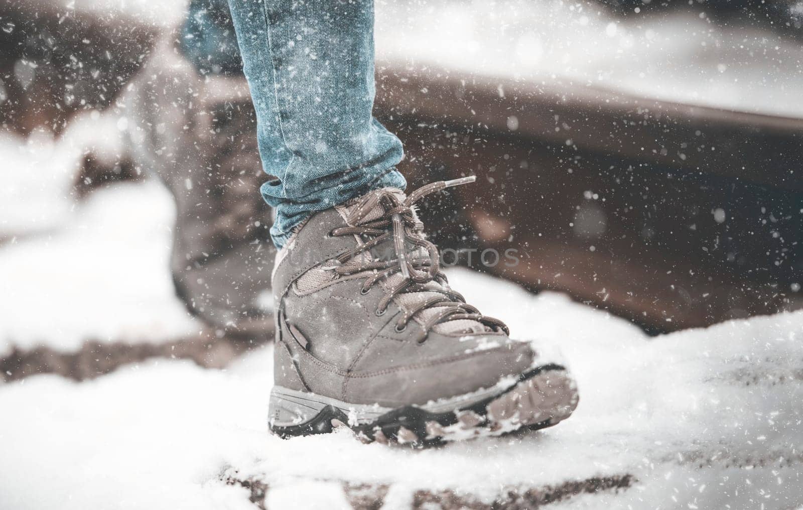 girl in boots walking on rails in winter