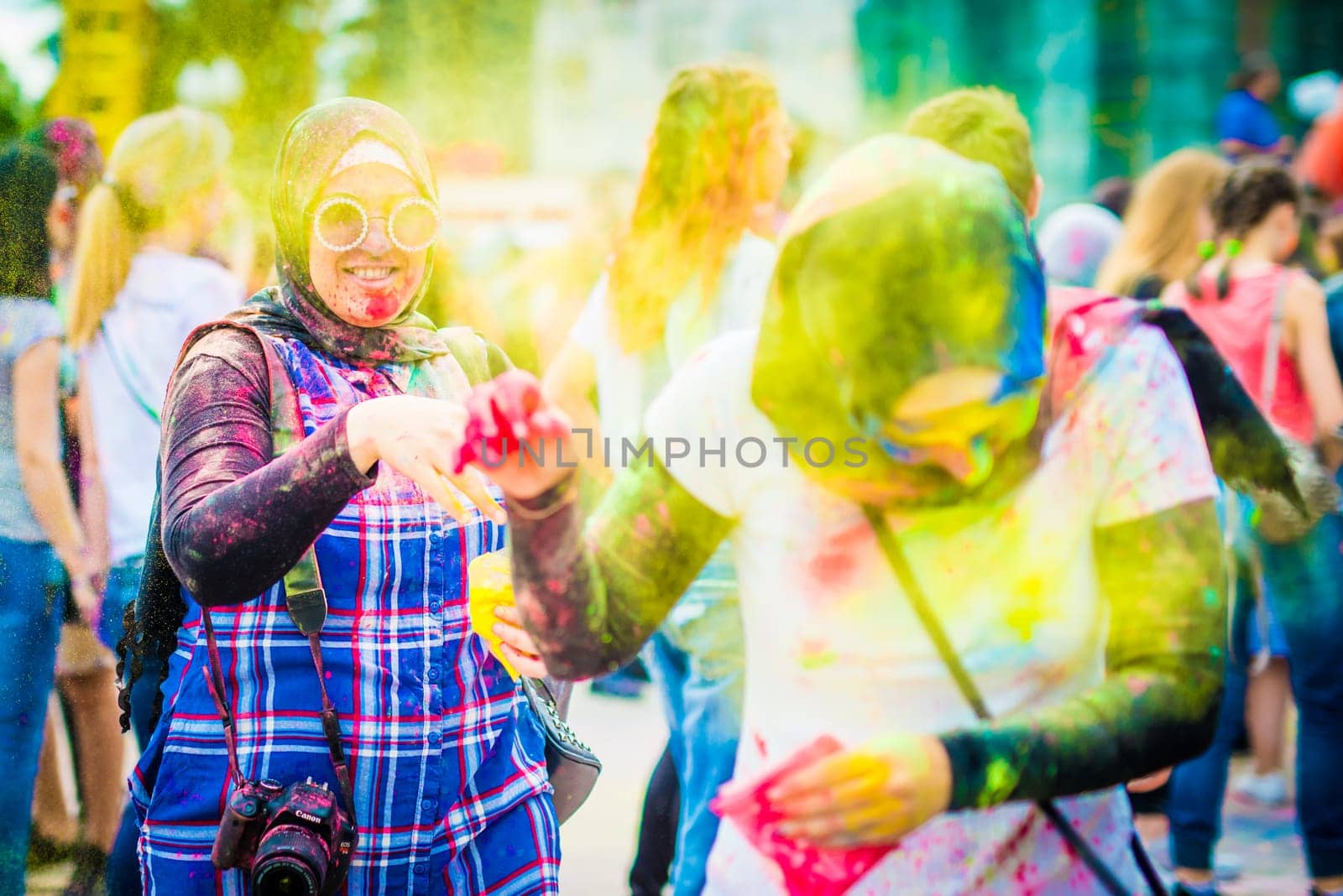 People sprinkle colorful paints during celebrating holi fest by GekaSkr