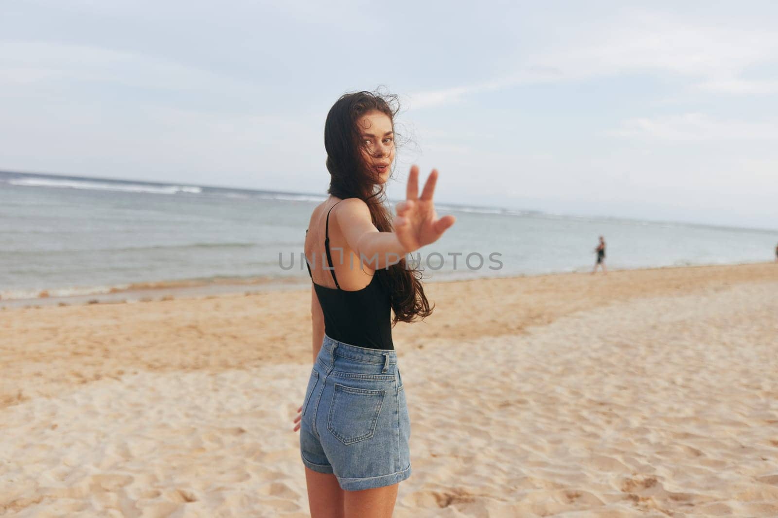 woman happy relax water smile person vacation sunset sand beach smiling leisure ocean sea running copy-space lifestyle summer peaceful shore happiness