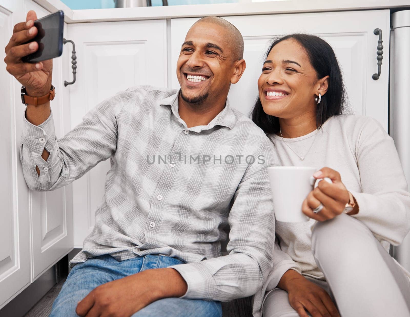Selfie, black couple and morning in a kitchen happy about new real estate and property purchase. House, smile and happiness of young people together taking a social media profile photo for web app.