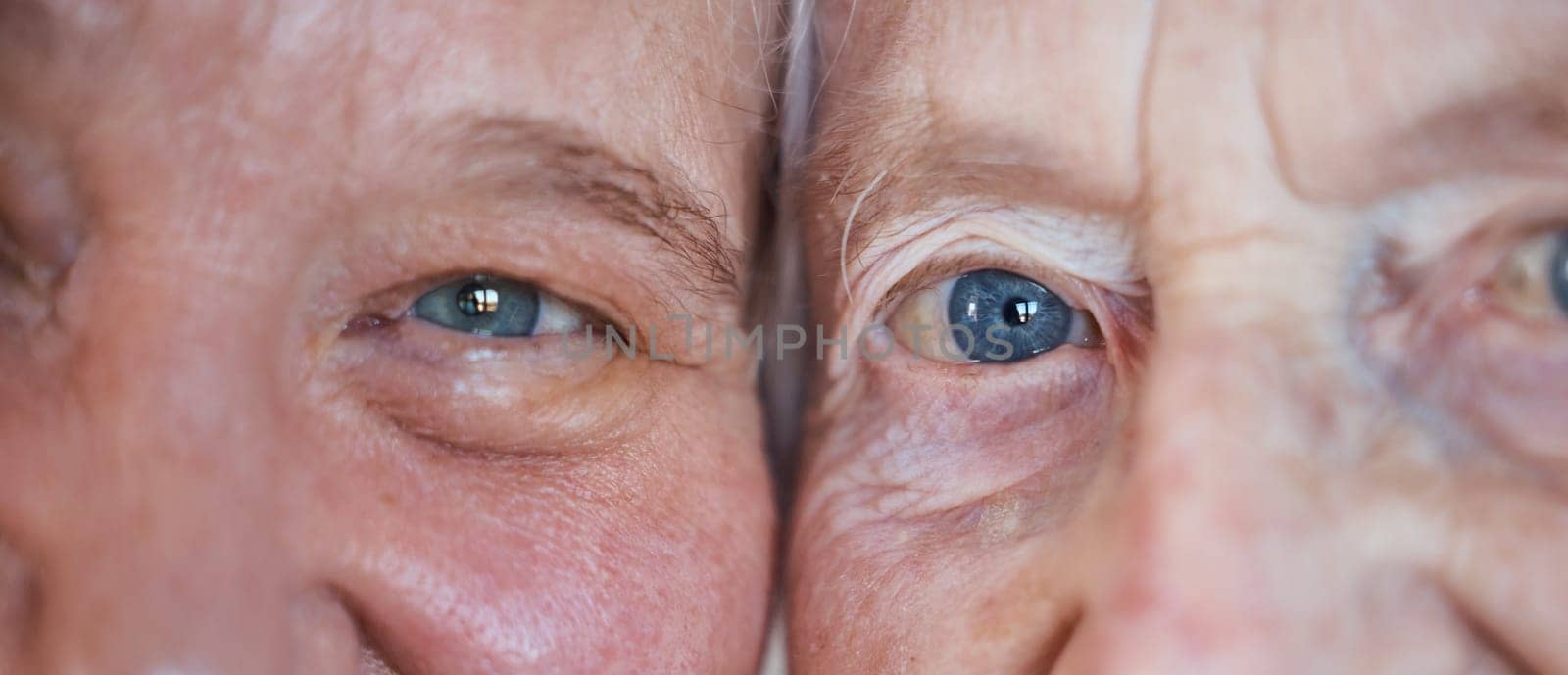 Face, eyes and love with a senior couple closeup inside enjoying retirement while spending time together. Blue eyes, vision and wrinkles with a mature man and woman bonding during a loving moment by YuriArcurs