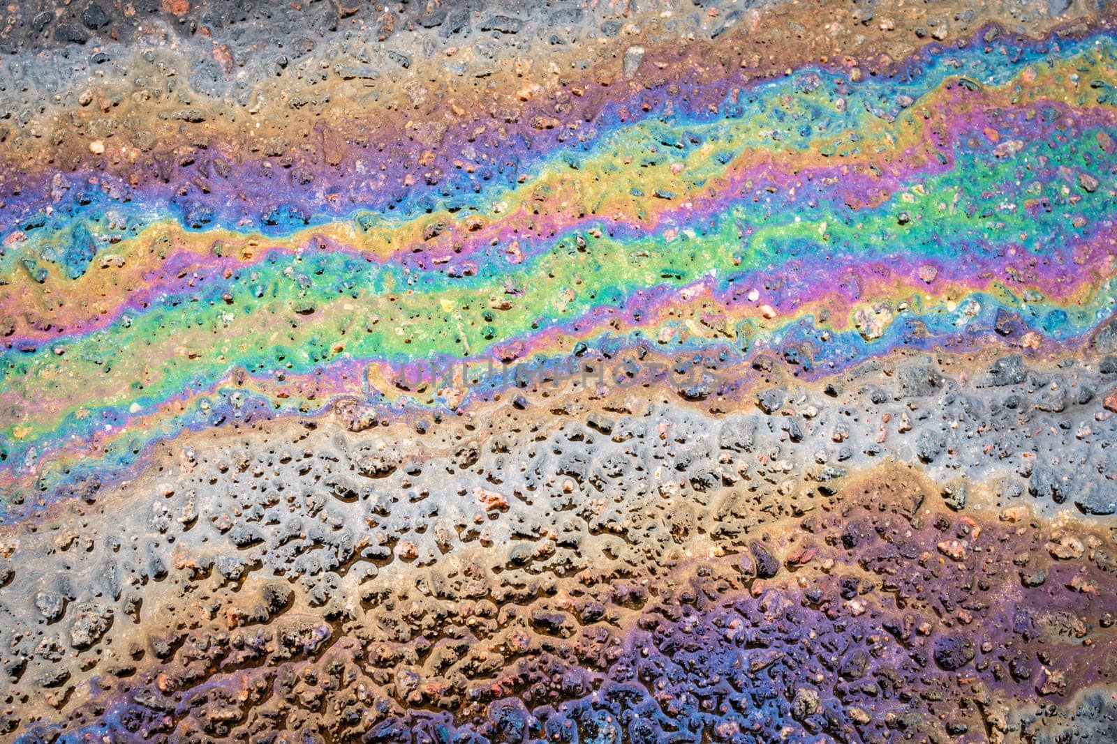 Traces and Stains of Oil or Gasoline on the Asphalt on the Road or Sidewalk