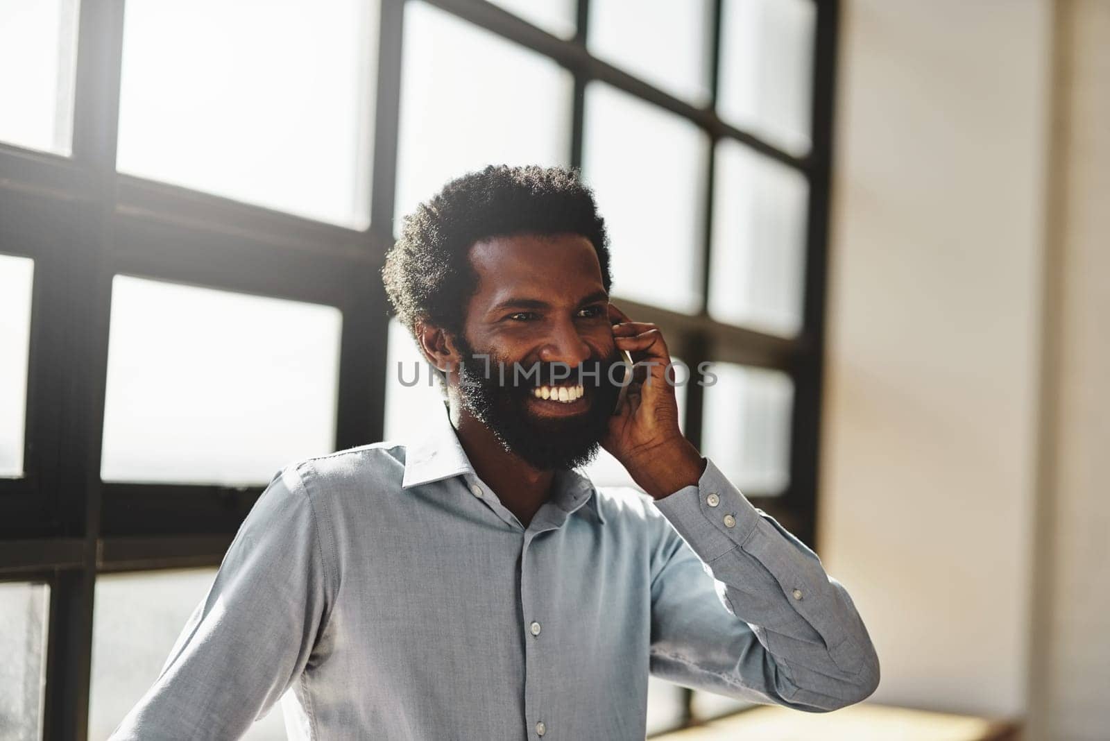 Idea, happy and communication business man at office with a smile or mindset of future success. Thinking, mobile contact and communication with a male employee talking in the office during his break.
