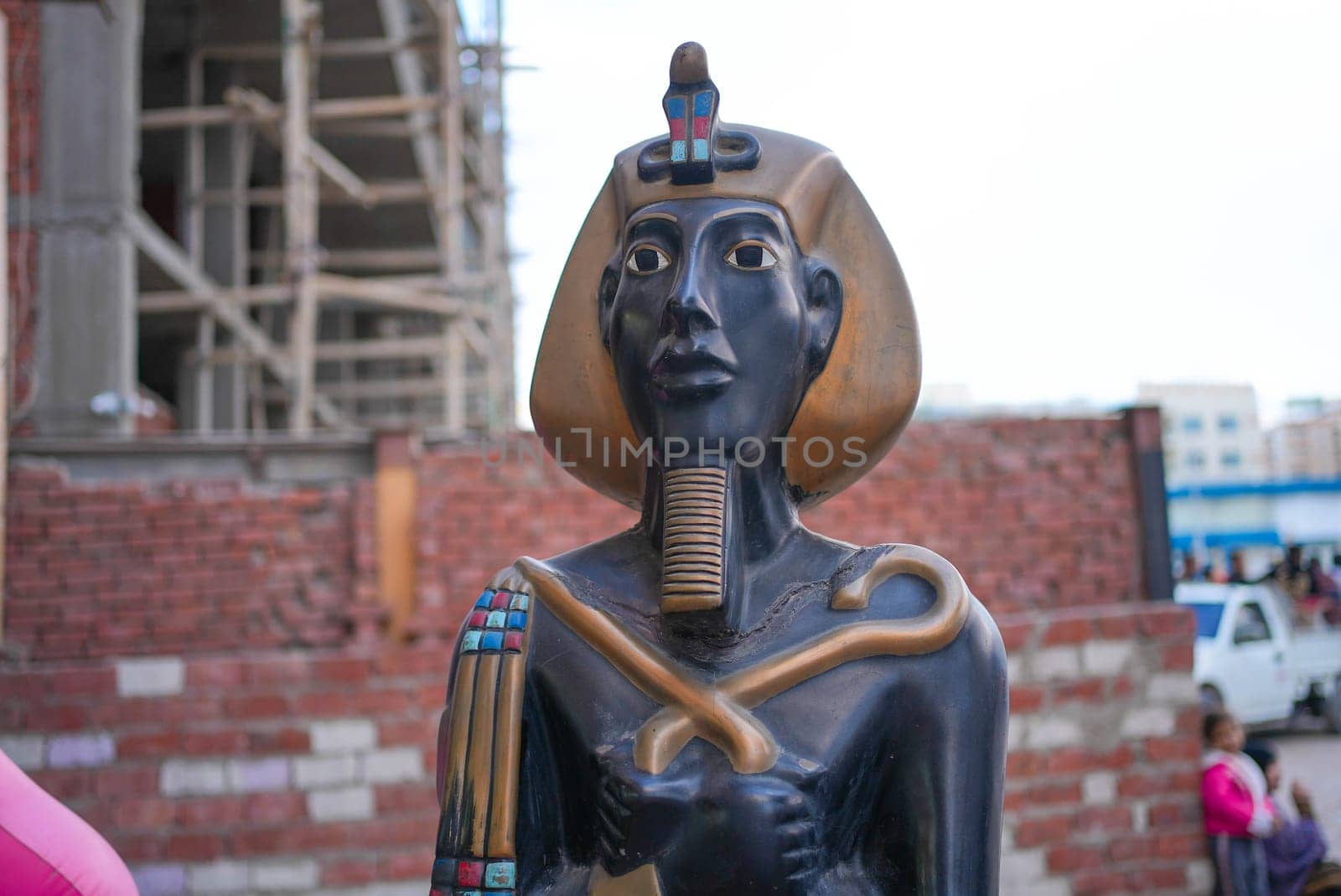 Egyptian statue with poverty in the background. High quality photo