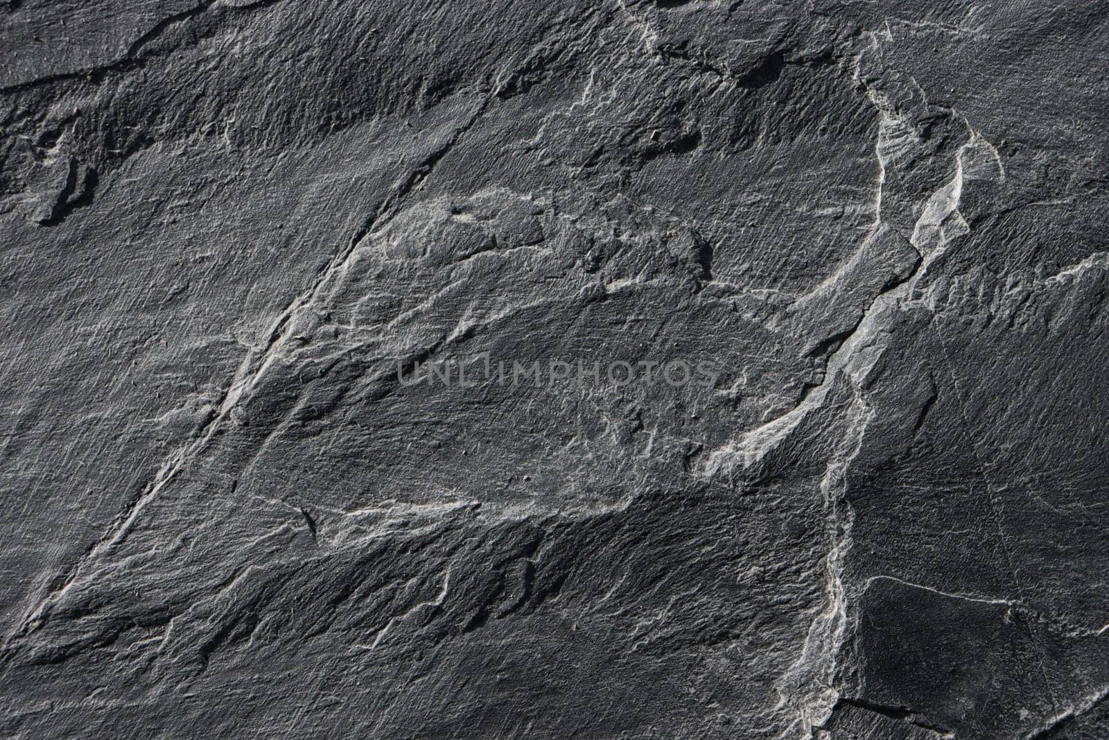 Texture of old gray granite on the wall.