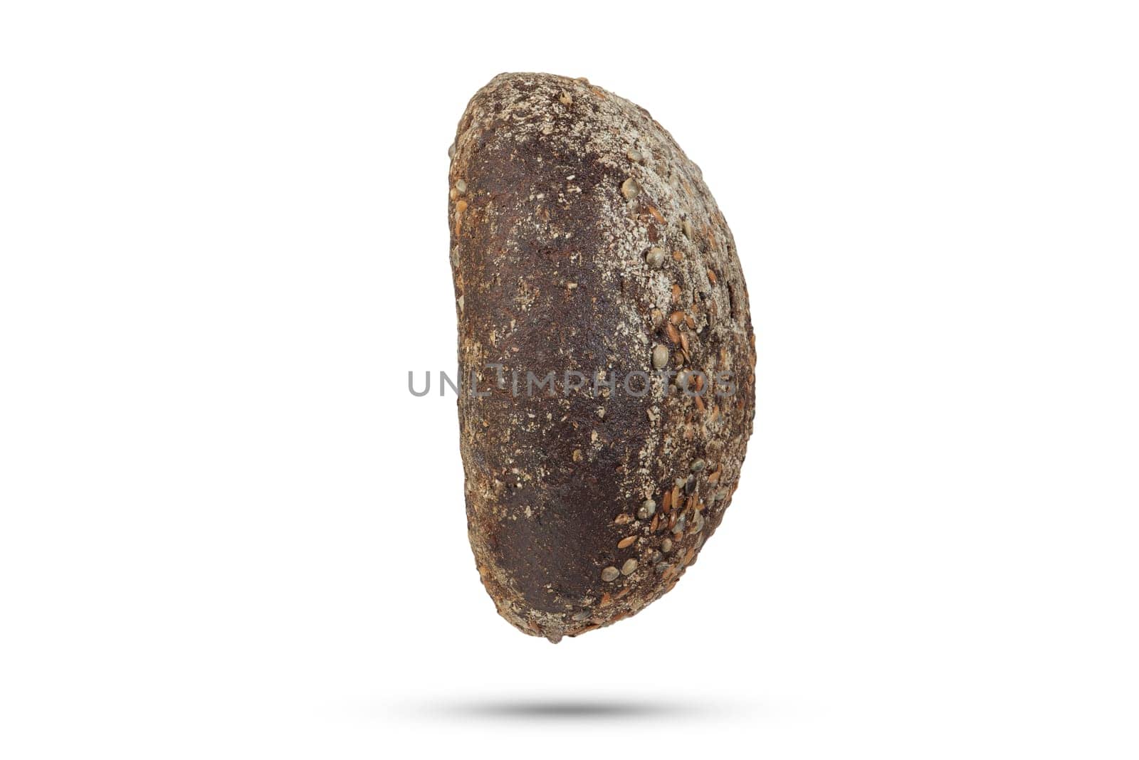 Black loaf of bread on a white isolated background. A loaf of black fresh bread with hemp seeds. Side view for insertion into a design or project. High quality photo